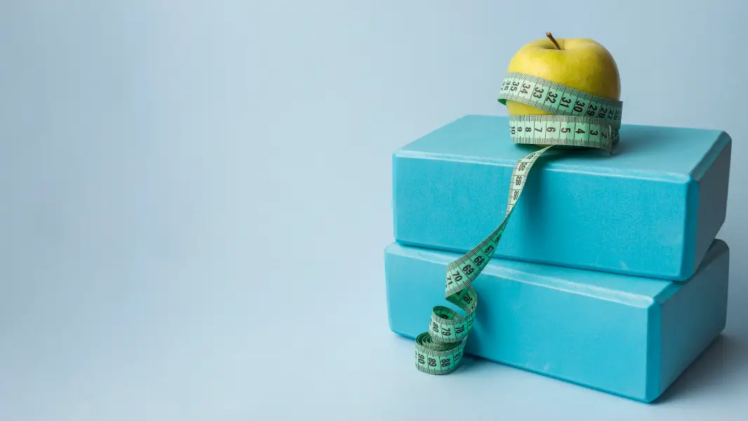 Lovely sport composition with apple and measuring tape